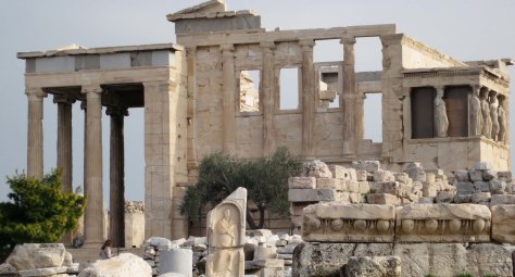 Another impressive building on the Acropolis is the Erechtheion. An olive tree decorates the front of the building.