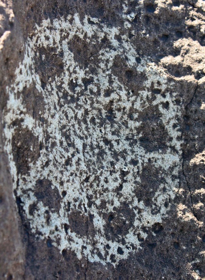 Circle petroglyph with possible sun at Three Rivers Petroglyph site.