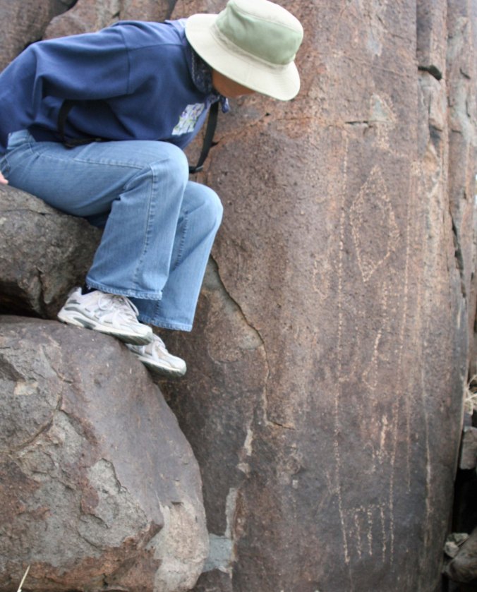 Peggy Mekemson checks out a petroglyph at Three Rivers Petroglyph site in southern New Mexico.