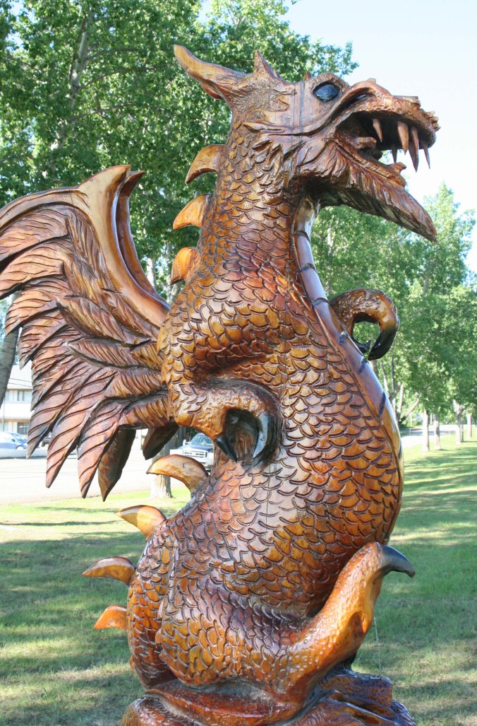 Peggy, who had just been kayaking on Dragon Lake in Quesnel, BC was immediately attracted to this dragon wood carving in Chetwynd.