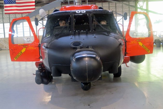 A front view of one of the Coast Guard's H-60s in the Hangar on Kodiak Island. Tony sits on the left in the picture while our grandson Connor sits on the right.