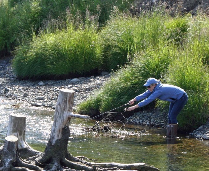 Here fish, fishy, fishy. Cammie tries to entice a salmon by dangling a lure in front of its mouth.
