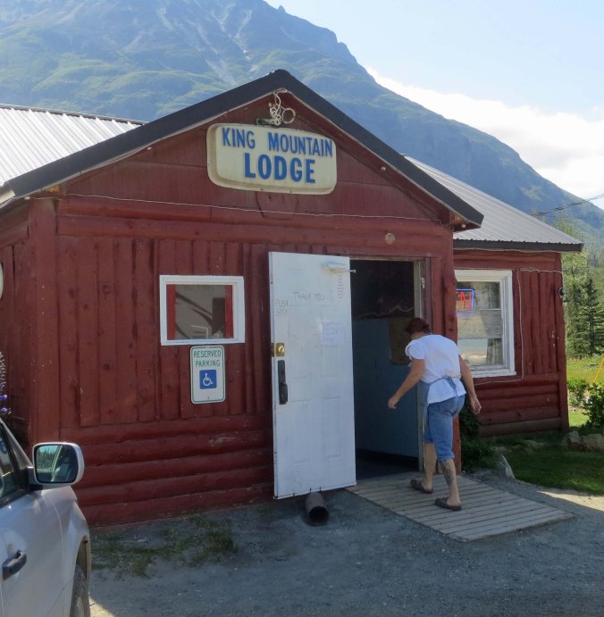 A hand printed sign at the King Mountain Lodge announced that food was available and we were hungry. In this photo, Darlene, the cook and owner's wife heads back inside after waving goodbye to us.