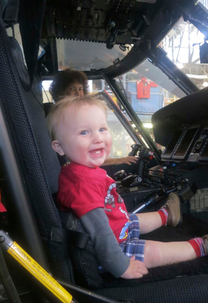 Our youngest grandson Chris gets to try out his dad's seat for size while Peggy looks on.