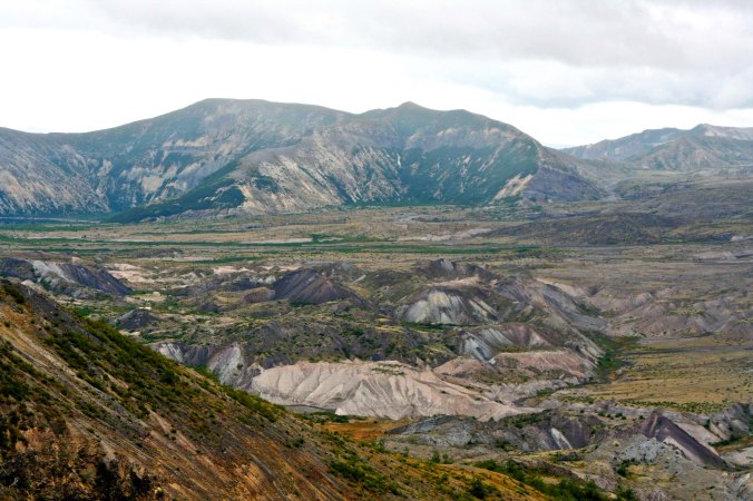Looking Northeast from Johnson Ridge, a small sliver of Spirit Lake can be seen at the base of the ridge. Once, it was a beautiful resort area. One of the biggest stories about the explosion was how Harry Truman, an elderly man who owned a lodge at the lake, refused to leave and dyed there.