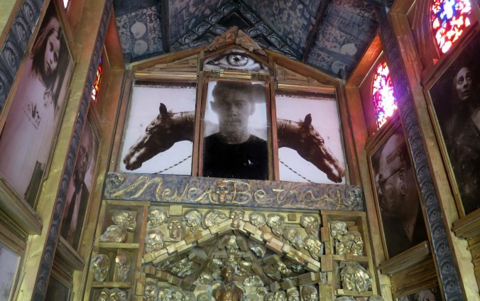 A view from inside the Photo Chapel. The person featured is Joey Jello, a member of Black Rock City's Department of Public Works who die in an auto crash just before 2012 Burning Man. His motto, shown below, was "Never Betray." It referred to his core values.