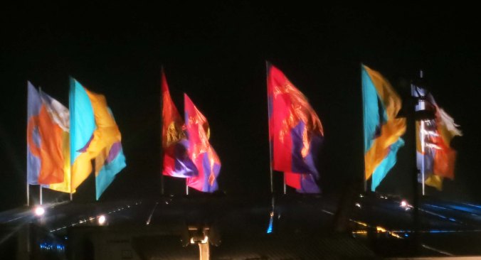 Burning Man Center Camp cafe flags at night.