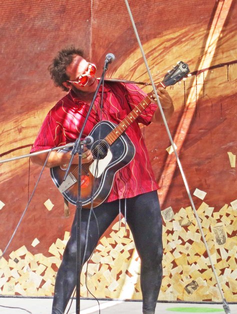 One might expect a guitar player to be found on the major stage at the Center Camp Cafe...