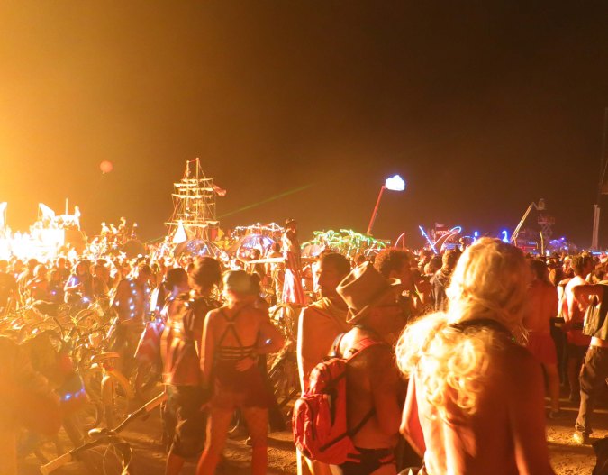 Flames from El Pulpo Mechanico light up the crowd that has gathered to watch the burning of the Man at Burning Man 2013.
