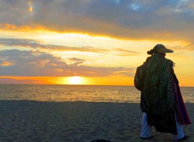 Puerto Vallarta beach vendor outlined by setting sun. Photo by Curtis Mekemson.)