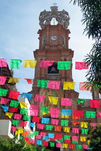 A view of the Church of Our Lady of Guadalupe through stree decorations in Puerto Vallarta. Photo by Curtis Mekemson.