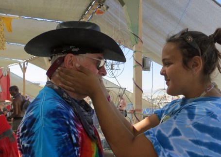 This woman had a unique way of gifting. She carried around an ice block and then put her icy hands on your face, which was perfect for a hot desert day. (Photo by Peggy Mekemson.)