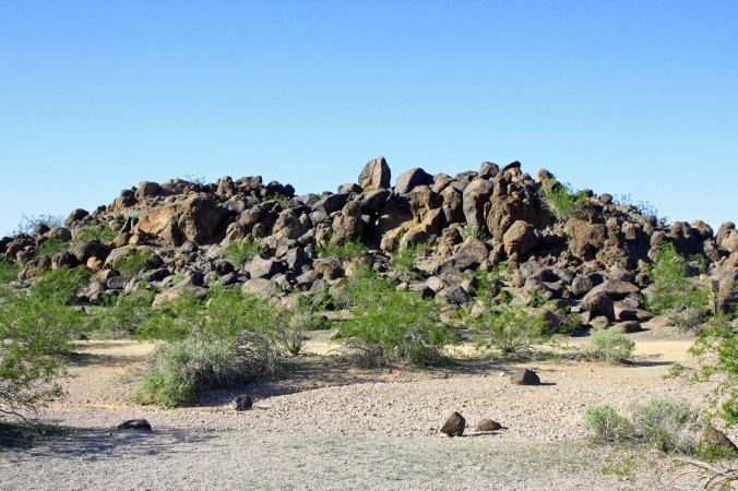 We arrived at Painted Rock Petroglyph Site in southern Arizona and found a large pile of volcanic rocks stacked up on the flat desert floor. Only when we got closer did we realize that the rocks were covered with Petroglyphs.