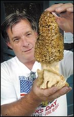 Our carpenter, Larry Baleau, shows off the huge morel mushroom he found while out identifying wildflowers.  (Photo by Bob Pennell of the Medford Tribune.)