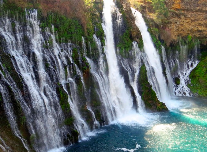 Water comes out from layers of rocks as well as over the top at Burney Falls.
