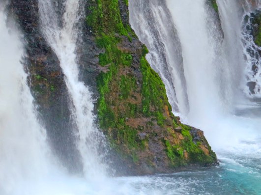 Water from Burney Falls crashes into the river.