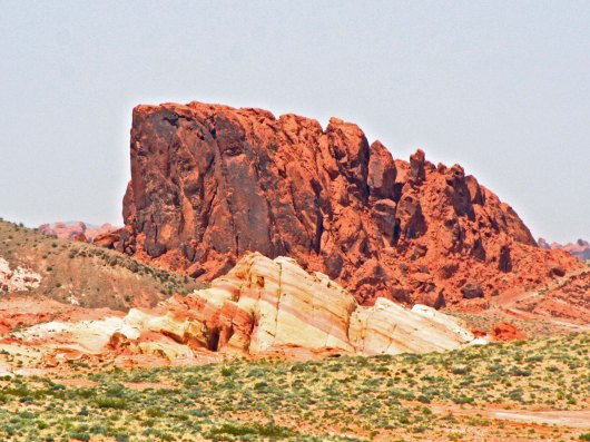 Peggy captured this impressive red mountain, which along with the red and tan sandstone rock on front provides another example of iron staining. The famous Red Wall of the Grand Canyon is also an example. (Photo by Peggy Mekemson.)