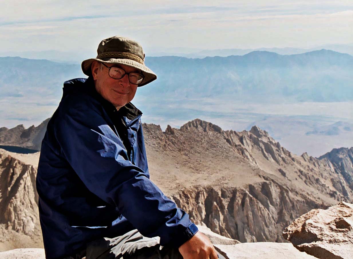 Curtis Mekemson sitting on top of Mt. Whitney.