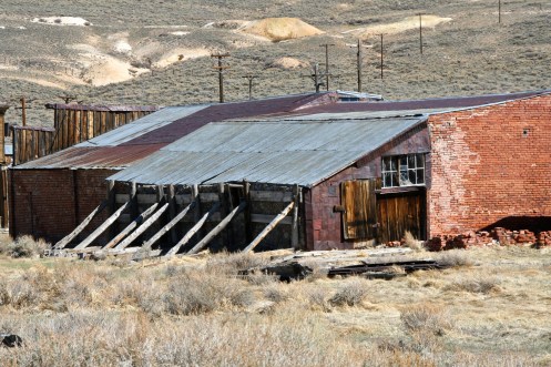 Building held up by support beams at Bodie State Park in California.