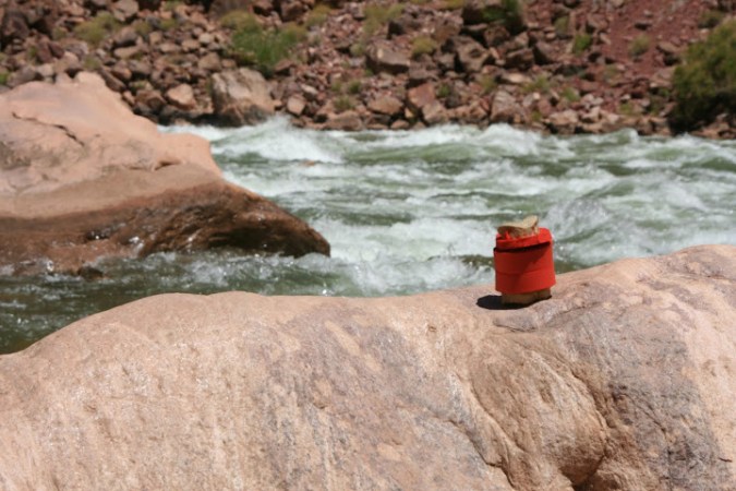 Checking out the rapids of the Little Colorado River as part of an 18 day trip down the Colorado through the Grand Canyon, Bone wears his life vest for safety.
