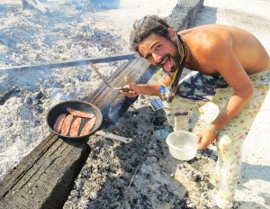 Cooking bacon on the coals left over from the burning of the man at Burning Man 2014.