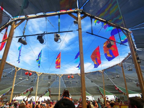 The middle of the Center Camp Cafe provides a large circular opening looking up at the sky and the flags.