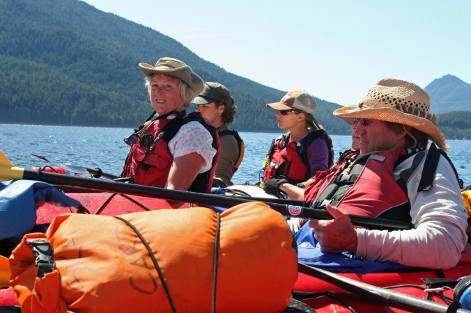 Kayakers with Kayak Adventure Tours raft up on Johnstone Strait in British Columbia when seeing a Killer Whale.