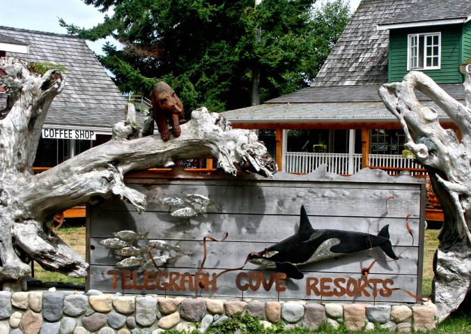 This sign, featuring an Orca, grizzly and salmon welcomes visitors to Telegraph Cove.