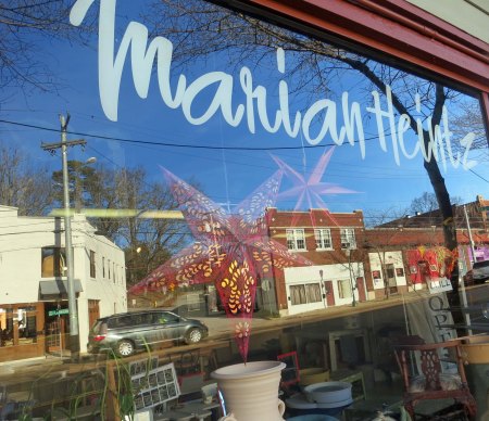 Chattanooga's Brainerd Road is reflected in the window of Marian's studio.