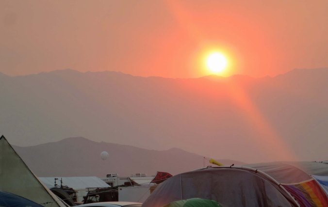 Sunset reflected through a dusty haze from our campsite at Black Rock City.