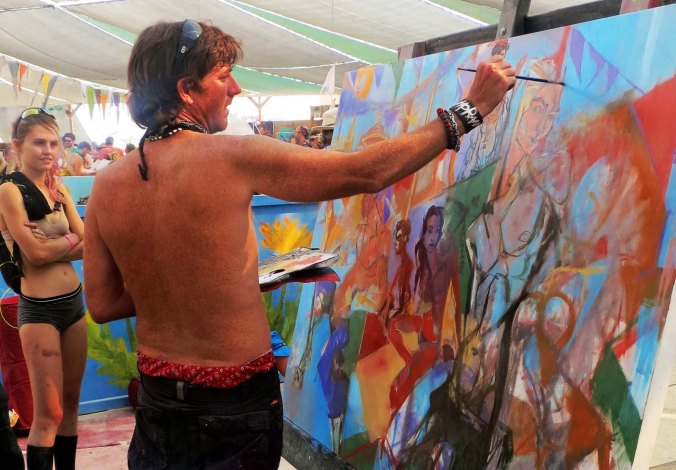 Another artist plies his trade while a Burner looks on. 