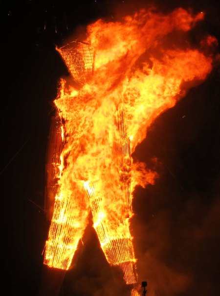 The Man goes to his fiery demise. Like the Phoenix, he will be back next year.