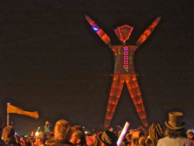 The Man, with arms raised, welcomes Burners to the night of his burn.