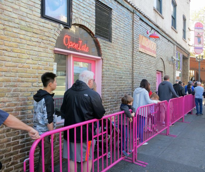 The ever present line of people waiting to get into the Voodoo Doughnut shop for their daily dose of sugar. 