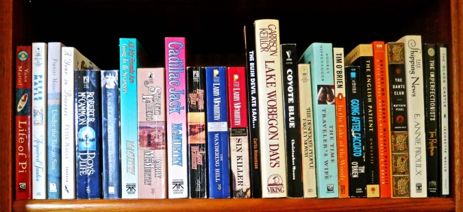 Another shelf of our books. BTW, I highly recommend the book just to the left of Lake Woebegone Days. (grin)