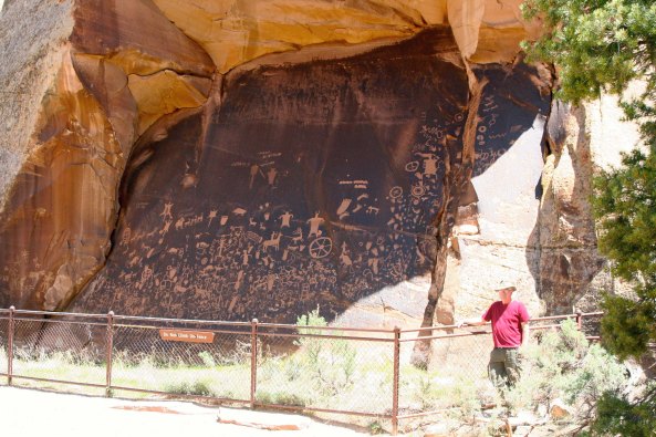 Newspaper Rock. I am standing beside the National Historic Site to provide perspective. (Photo by Peggy Mekemson.)