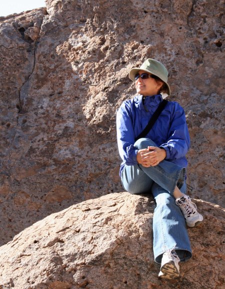 Paths wander in and among the square mile park. Convenient rocks invite hikers, such as Peggy, to sit and enjoy the beauty and solitude.