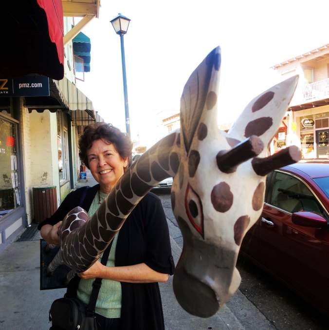 Peggy fell in love with this balsa wood giraffe we found in Jackson, California. So the giraffe came home with us. Little did we think it would have a taste for petunias.