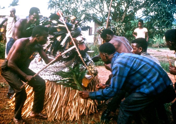 The Grebo men carefully tended the Bush Devil.