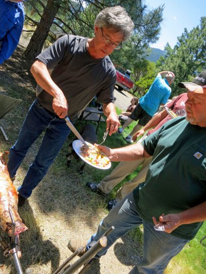 Bryan serves on neighbor Jim, who donated the goat for the feast.