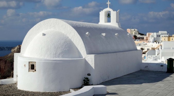 A back view of the church with Oia, Santorini stretching out in front.