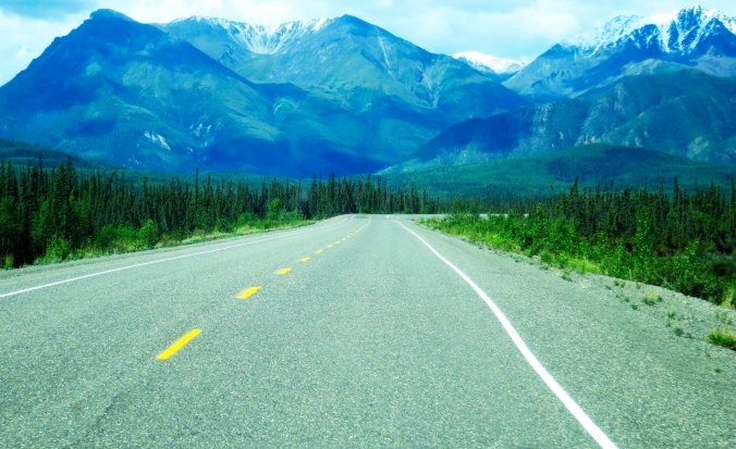 Sights along the the Alaska Highway include towering mountains...