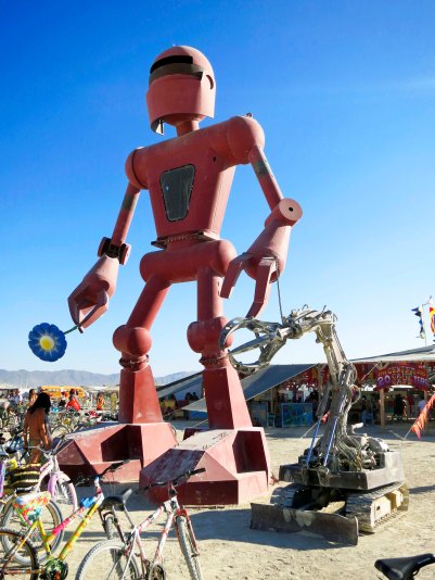 This robot with his dog and a flower was in front of the Center Camp Cafe. He would raise the flower up to his nose and sniff it.