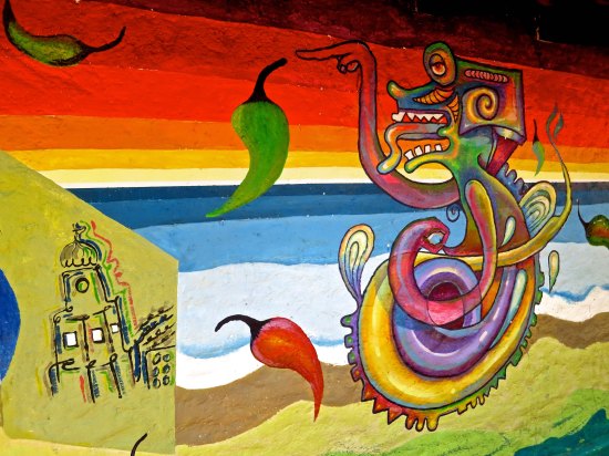 An iguana of a different stripe? This is one pointing to one of life's great pleasures: hot peppers.