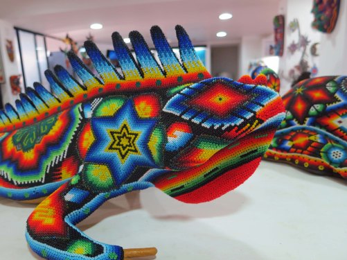I haven't heard of iguanas being a choice for shape shifting. Maybe that's why this Huichol piece looks sad. 