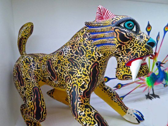There is no apparent shape shifting in the Oaxaca saber toothed tiger. Or in the peacock behind it.