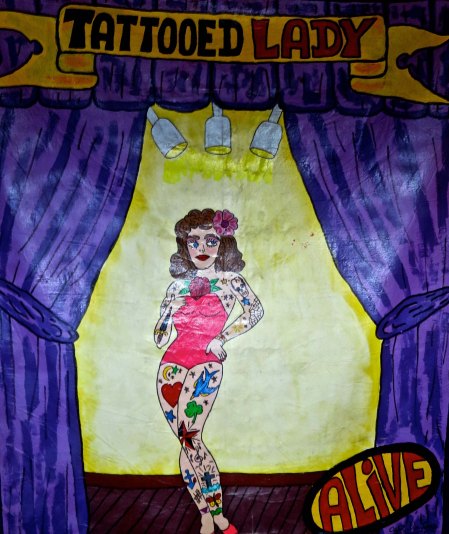 Side show poster art at Triangle Tattoo in Fort Brag.