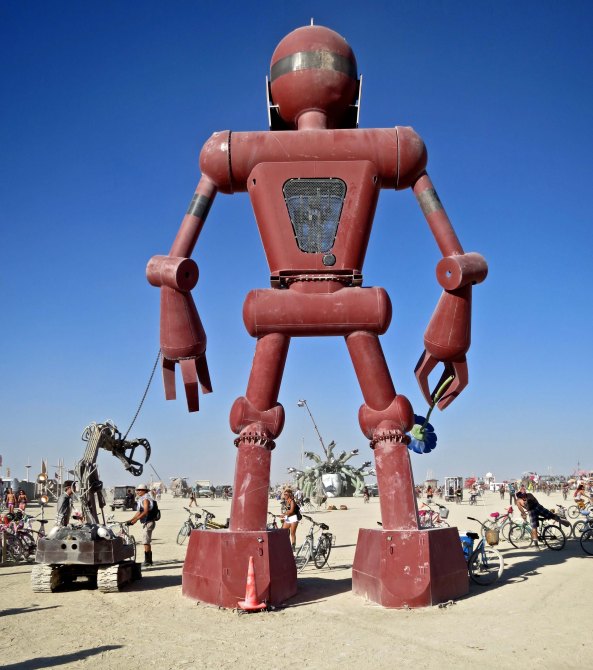 Just a 30 foot robot boy walking his robot dog at Burning Man 2015. The boy holds a flower in his right hand that he raises up to his nose and 'smell.' The endless creativity at Burning Man has brought me back to event time and again over the years.