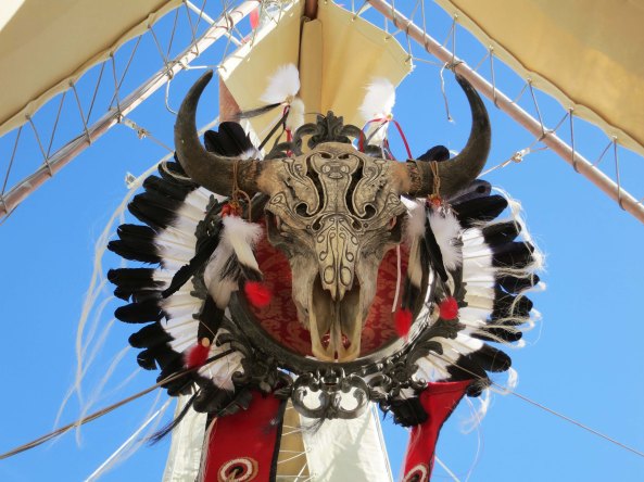 This impressively carved bull skull with its adorning feathers was hung above the organ.