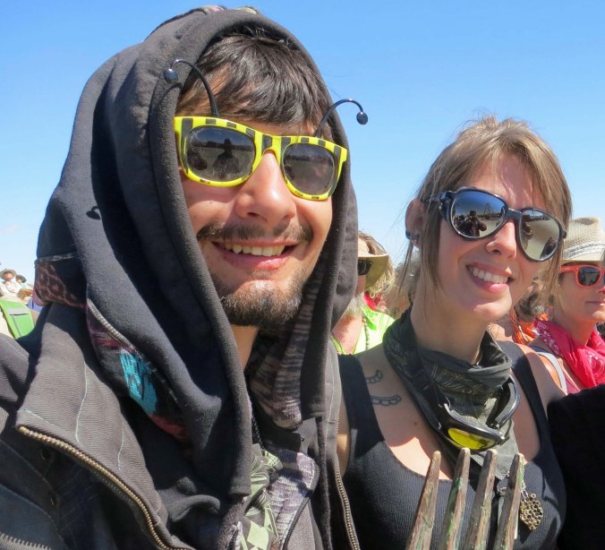 This young couple stood next to me as we watched a burning piano be tossed 50 or so yards up the Playa. Glasses form an important part of Burner's costumes.